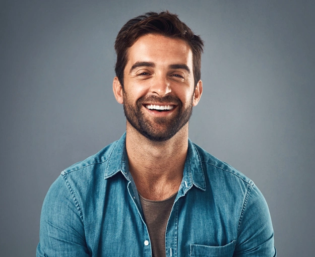 Smiling man after getting teeth whitening treatment